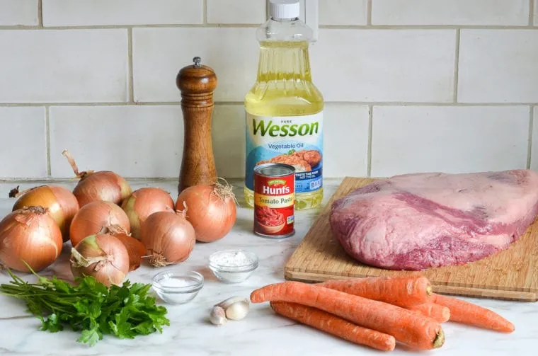 seasoned brisket and cutting onion and garlic