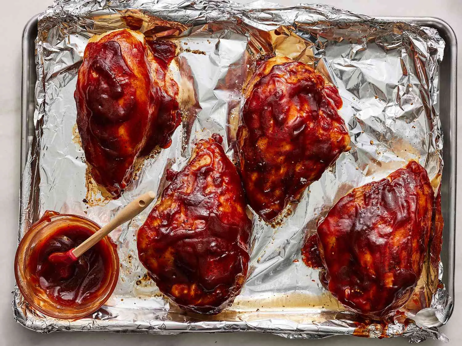 Serving tasty boneless chicken breast with barbecue sauce, oven-baked to perfection.
